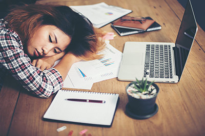 Young hipster woman tired for work and nap on workplace.